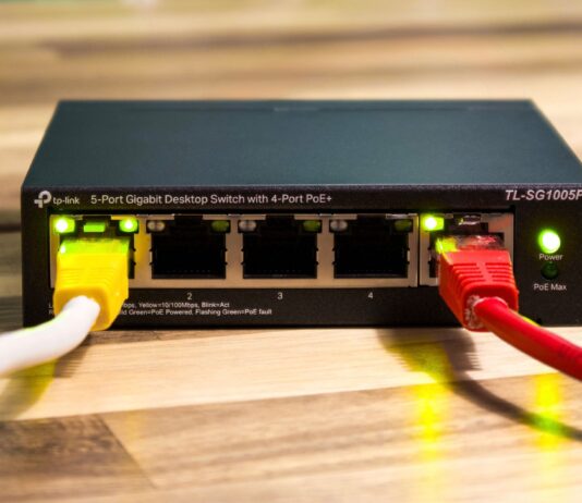 Switch Ethernet TP-Link z podłączonymi kolorowymi kablami sieciowymi